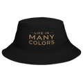 Black cotton twill bucket hat with the Life In Many Colors logo embroidered in gold across the front